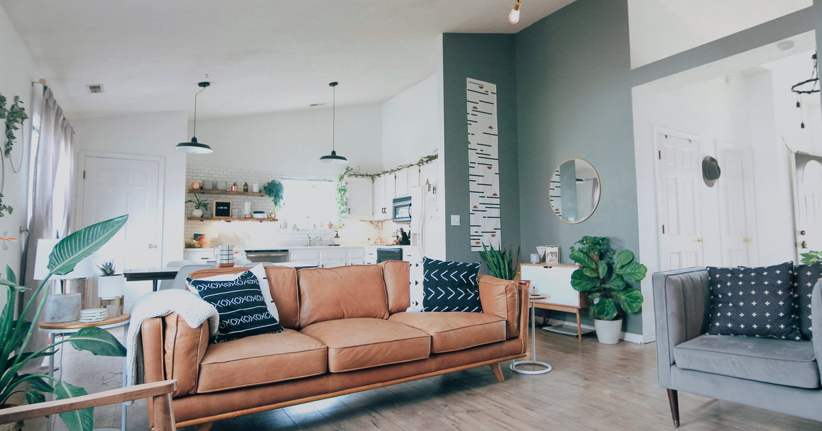 A bright open house living room showing setup for visitor check-in and lead capture.